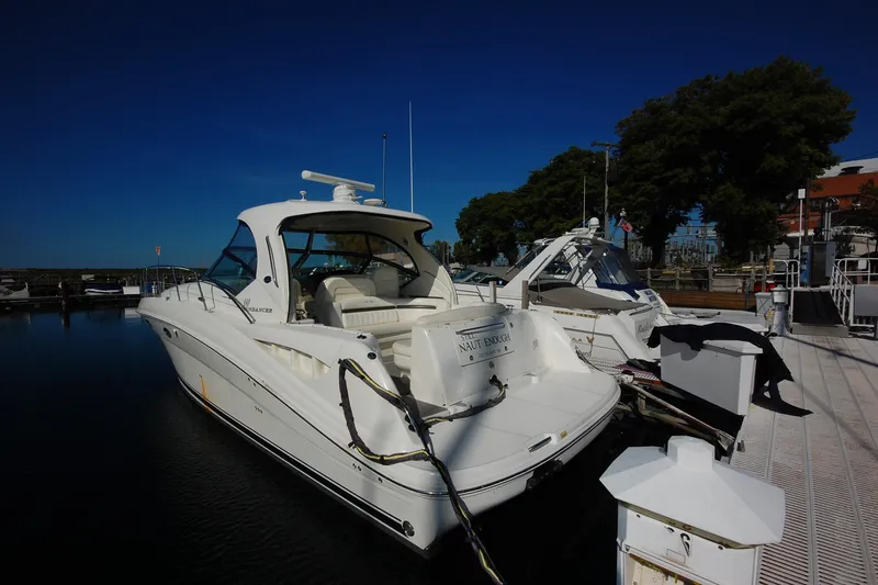 Slide: The Image of 2004 Sea Ray 390 Sundancer yacht docked at marina under clear blue sky. - 16