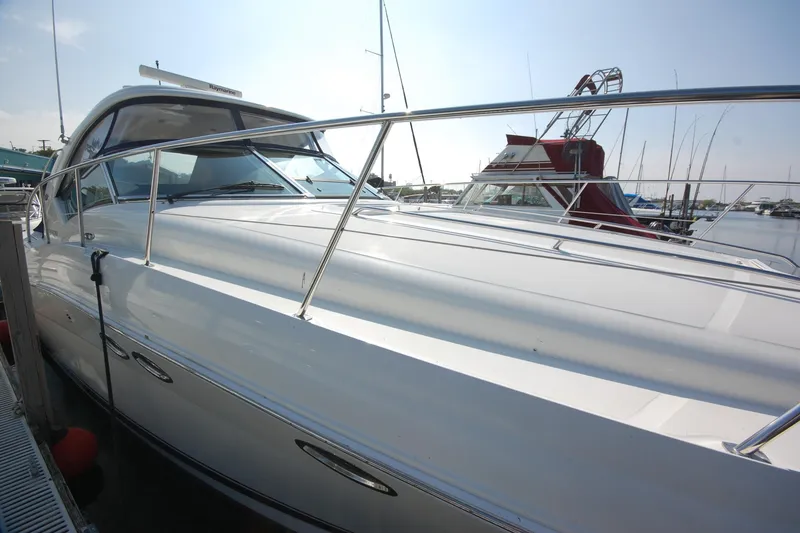 Slide: The Image of 2004 Sea Ray 390 Sundancer yacht docked at marina, showcasing sleek design and polished exterior. - 2