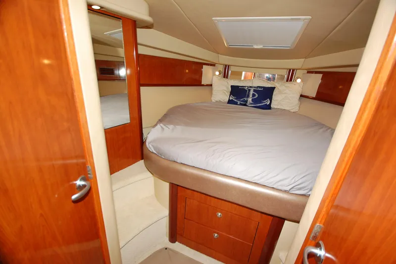 Slide: The Image of Luxurious cabin interior of 2004 Sea Ray 390 Sundancer yacht with cozy bed and wooden finish. - 27