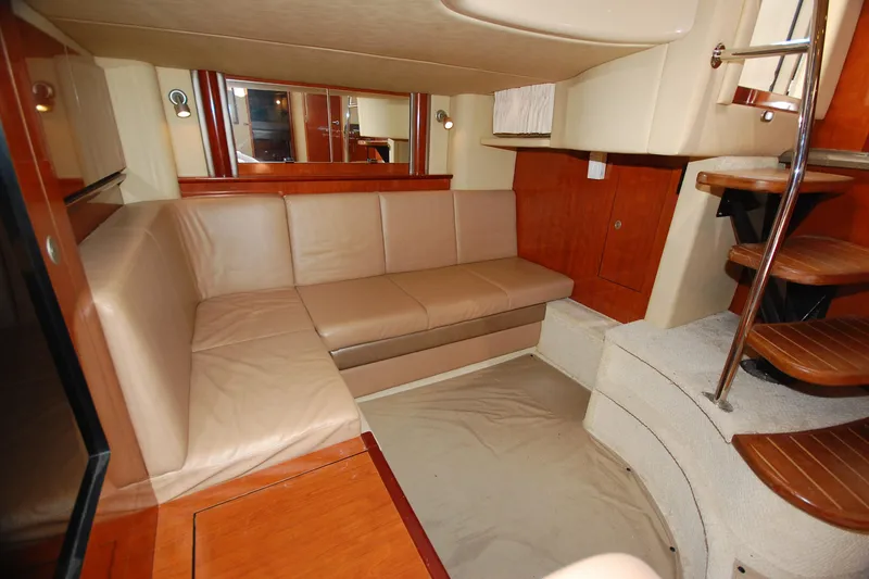 Slide: The Image of Interior of 2004 Sea Ray 390 Sundancer yacht with beige leather seating and wooden accents. - 29