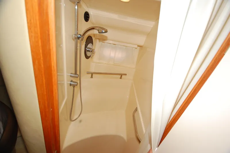 Slide: The Image of Shower area in 2004 Sea Ray 390 Sundancer yacht, featuring modern fixtures and compact design. - 34