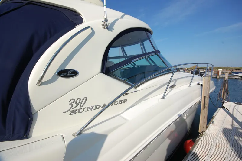 Slide: The Image of 2004 Sea Ray 390 Sundancer yacht docked at marina under clear blue sky. - 4