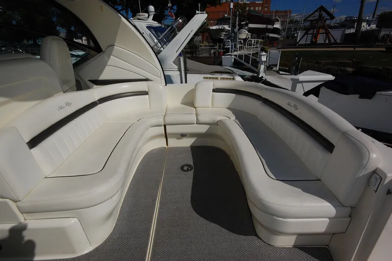Slide: The Image of 2004 Sea Ray 390 Sundancer boat with spacious white seating area. - 8