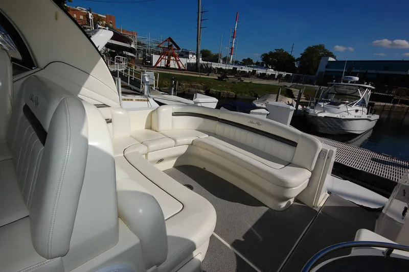 Slide: The Image of 2004 Sea Ray 390 Sundancer yacht with luxurious white seating at a marina. - 9