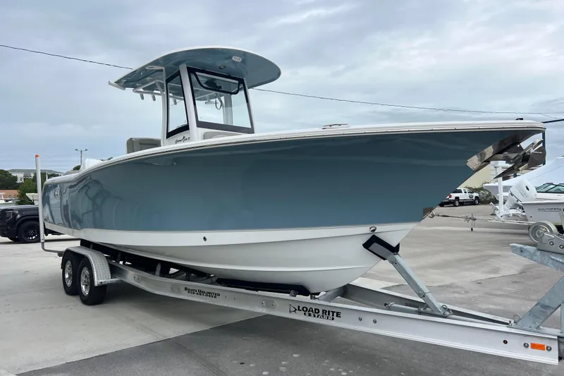 Slide: The Image of 2025 Sea Hunt Gamefish 27 Forward Seating boat on trailer, side view. - 4