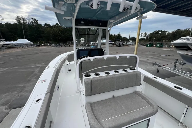 Slide: The Image of 2025 Sea Hunt Gamefish 27 boat with forward seating, docked in a marina. - 6