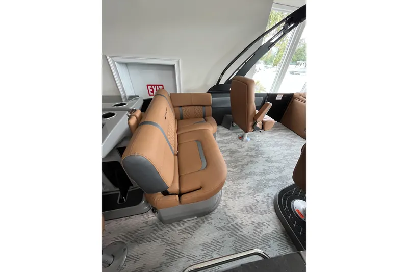Slide: The Image of 2026 Starcraft RX 25 DL DC boat interior with tan seating and modern design. - 10