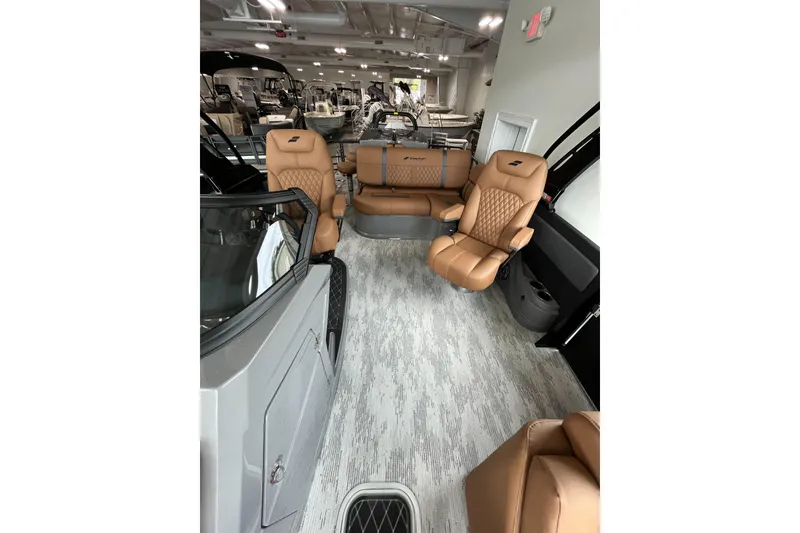Slide: The Image of Luxurious interior of 2026 Starcraft RX 25 DL DC boat with tan leather seating. - 11