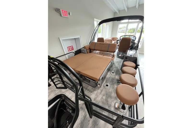Slide: The Image of 2026 Starcraft RX 25 DL DC boat interior with tan seating and modern design. - 8