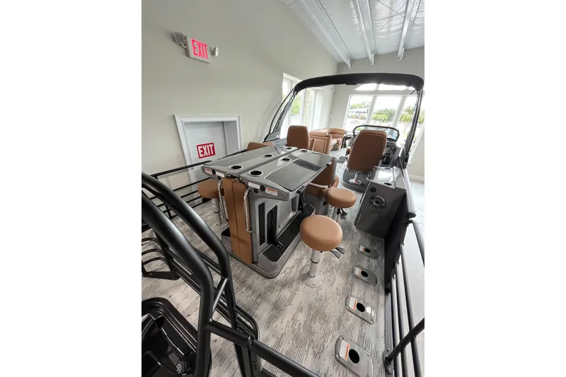 Slide: The Image of 2026 Starcraft RX 25 DL DC boat interior with seating and control panel. - 9