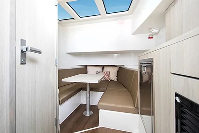 Slide: The Image of 2026 Cruisers Yachts 38 VTR interior with skylight, dining area, and modern furnishings. - 8