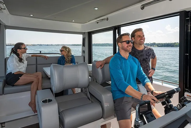 Slide: The Image of People enjoying a ride on a 2026 Cruisers Yachts 38 VTR, with scenic water views. - 6