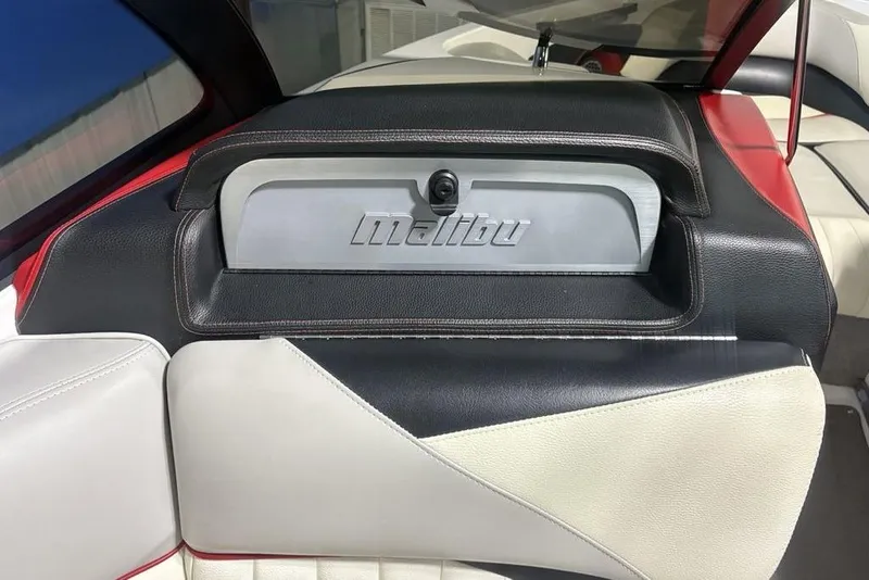 Slide: The Image of 2015 Malibu Wakesetter 247 LSV interior with logo, featuring black, white, and red upholstery. - 10