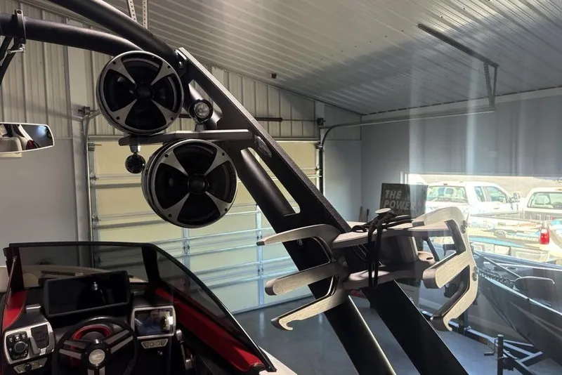 Slide: The Image of 2015 Malibu Wakesetter 247 LSV boat interior with speakers and wakeboard rack. - 19