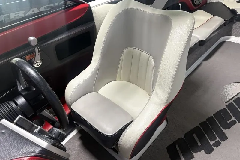 Slide: The Image of 2015 Malibu Wakesetter 247 LSV interior with white captain's chair and steering wheel. - 25