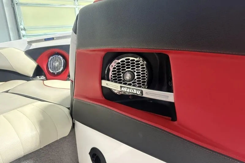Slide: The Image of 2015 Malibu Wakesetter 247 LSV interior with red and black speaker detail. - 6