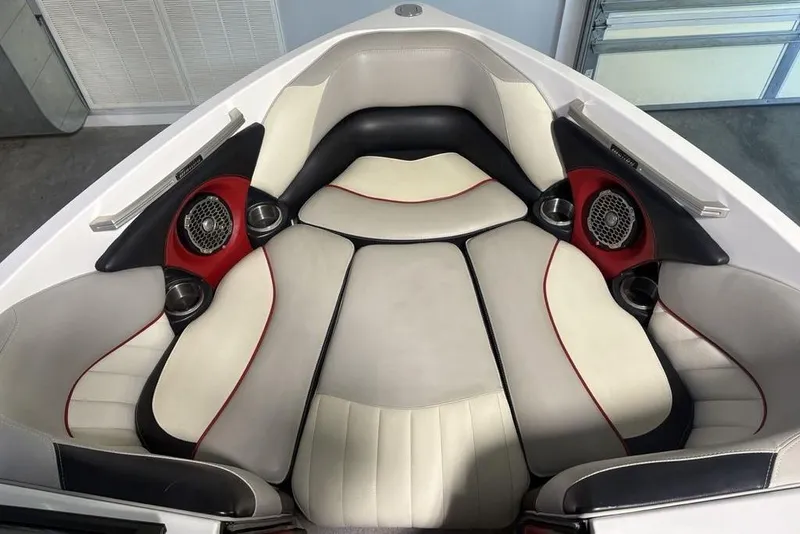 Slide: The Image of 2015 Malibu Wakesetter 247 LSV interior with cushioned seating and built-in speakers. - 9