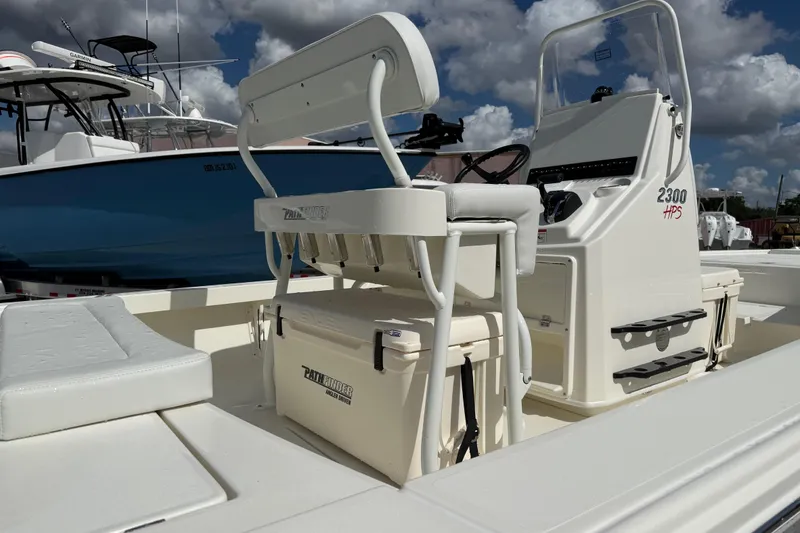 Slide: The Image of 2026 Pathfinder 2300 HPS boat interior with steering console and seating under clear blue sky. - 7