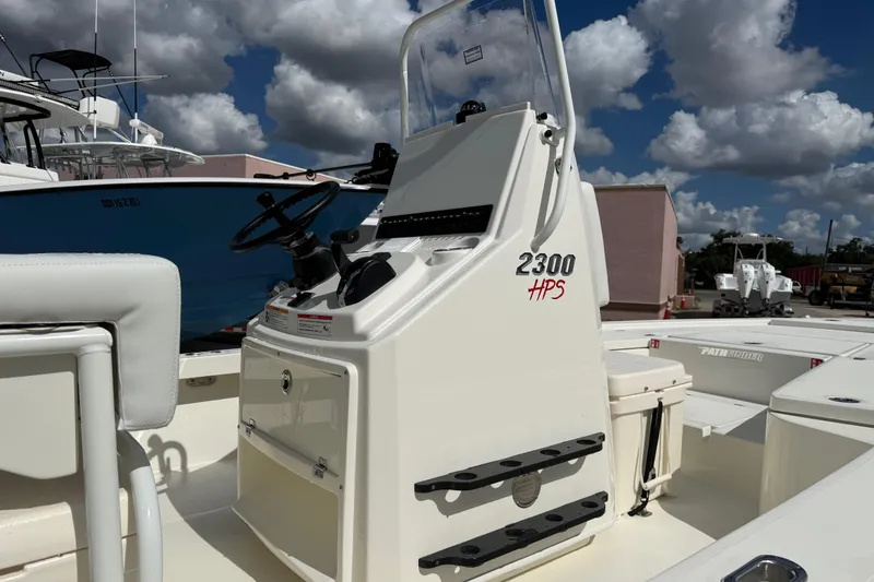 Slide: The Image of 2026 Pathfinder 2300 HPS boat console with steering wheel and controls, outdoor setting. - 9