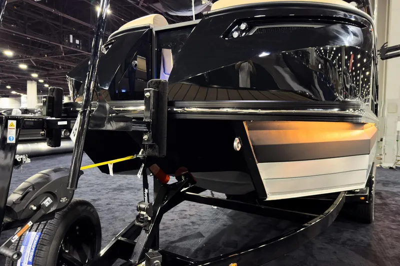 Slide: The Image of 2026 Montara Surf Boss EVO - SLDH 25' boat on display at an indoor exhibition. - 2