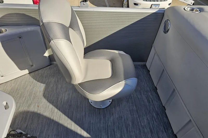 Slide: The Image of 2022 Bennington SX 21 Fishing boat interior with a swivel seat and carpeted floor. - 110