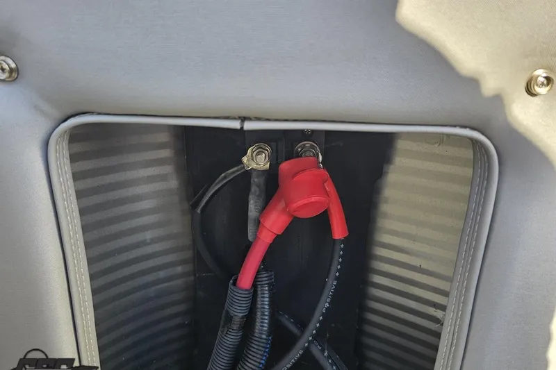 Slide: The Image of Battery compartment of 2022 Bennington SX 21 Fishing boat with red and black cables. - 113