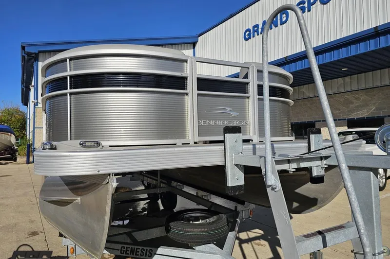 Slide: The Image of 2022 Bennington SX 21 Fishing pontoon boat on trailer, outdoor dealership display. - 12