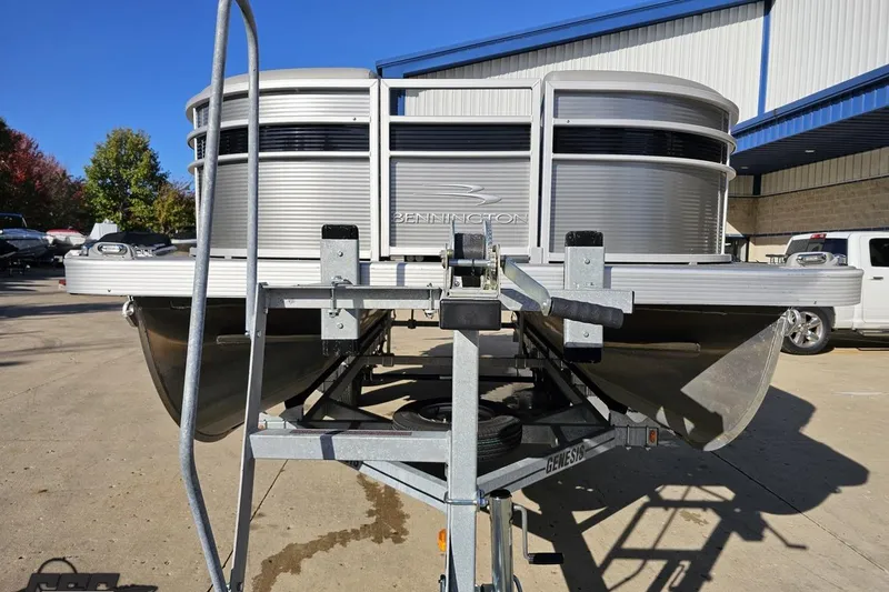 Slide: The Image of 2022 Bennington SX 21 Fishing pontoon boat on trailer, outdoor dealership setting. - 13