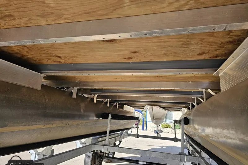 Slide: The Image of Underneath view of a 2022 Bennington SX 21 Fishing pontoon boat on a trailer. - 15