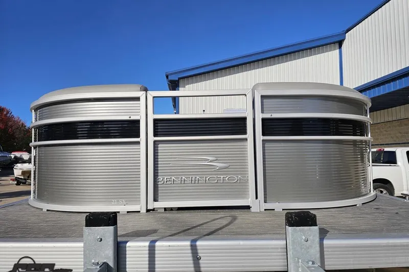 Slide: The Image of 2022 Bennington SX 21 Fishing pontoon boat front view, silver exterior, outdoor setting. - 16