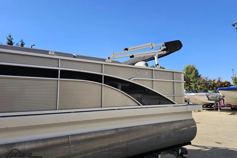Slide: The Image of 2022 Bennington SX 21 Fishing pontoon boat on trailer under clear blue sky. - 24