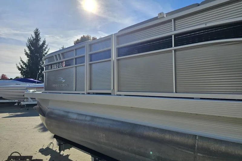 Slide: The Image of 2022 Bennington SX 21 Fishing pontoon boat in sunlight, side view. - 26