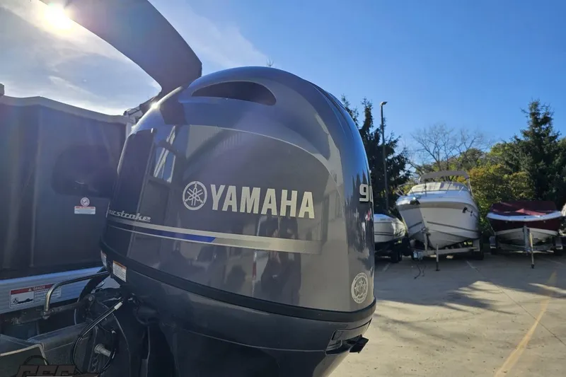 Slide: The Image of Yamaha outboard motor on 2022 Bennington SX 21 Fishing boat, sunny day, boats in background. - 30