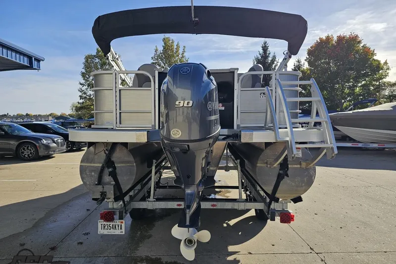 Slide: The Image of 2022 Bennington SX 21 Fishing boat with Yamaha 90 engine, parked on a trailer. - 32