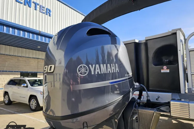 Slide: The Image of Yamaha 90 outboard motor on 2022 Bennington SX 21 Fishing boat, dealership background. - 33