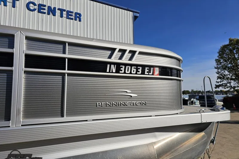 Slide: The Image of 2022 Bennington SX 21 Fishing pontoon boat at a marina, side view. - 4