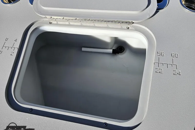 Slide: The Image of Open storage compartment on 2022 Bennington SX 21 Fishing boat with measurement markings. - 48