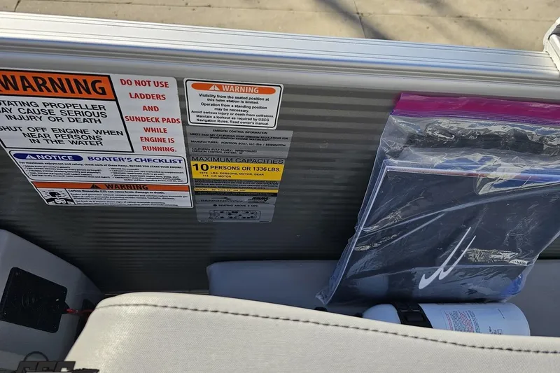 Slide: The Image of 2022 Bennington SX 21 Fishing boat safety warnings and capacity labels. - 61