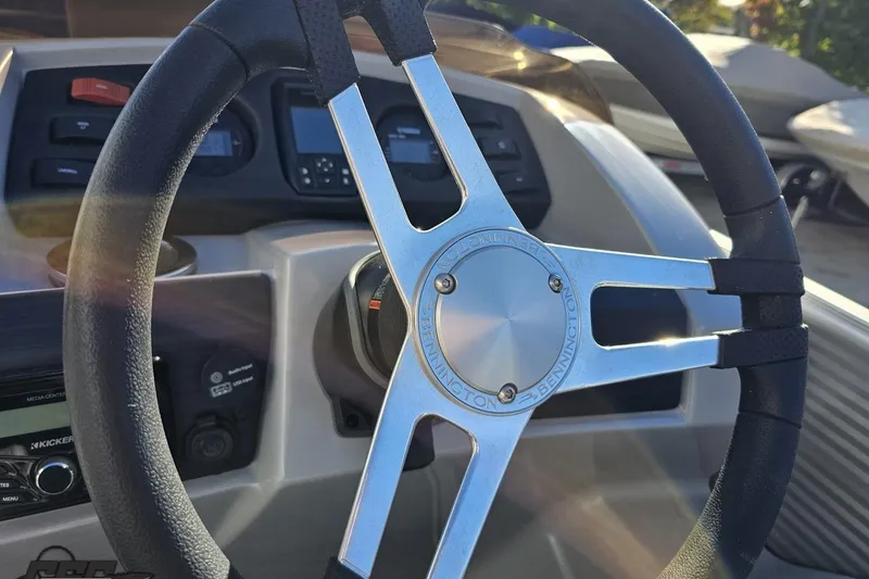 Slide: The Image of Steering wheel of 2022 Bennington SX 21 Fishing boat, featuring modern dashboard controls. - 66