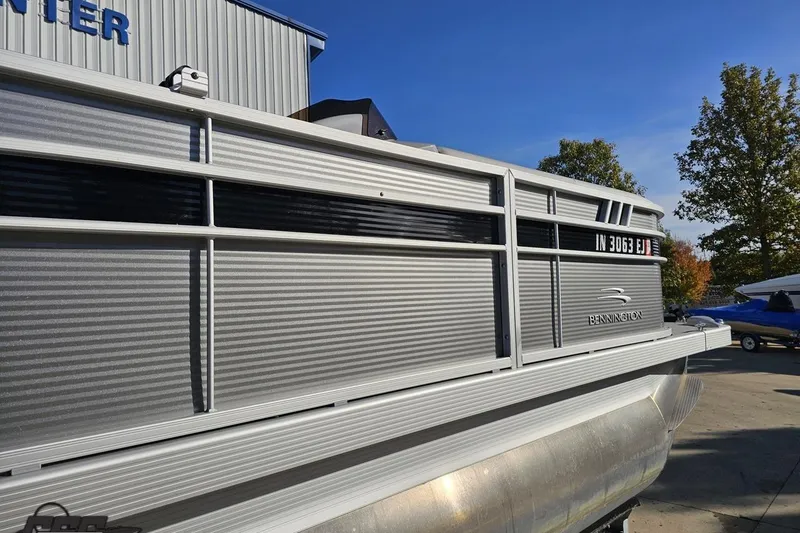 Slide: The Image of 2022 Bennington SX 21 Fishing pontoon boat, silver exterior, parked outdoors. - 7