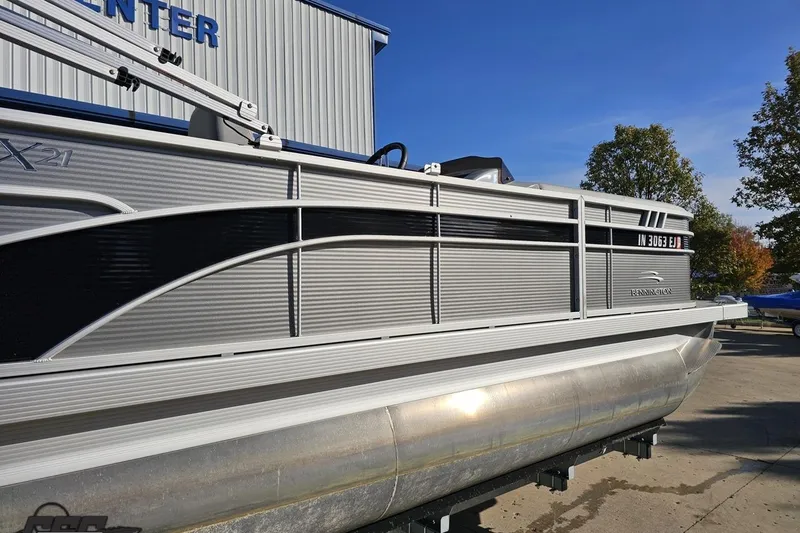 Slide: The Image of 2022 Bennington SX 21 Fishing pontoon boat displayed outdoors on a sunny day. - 8