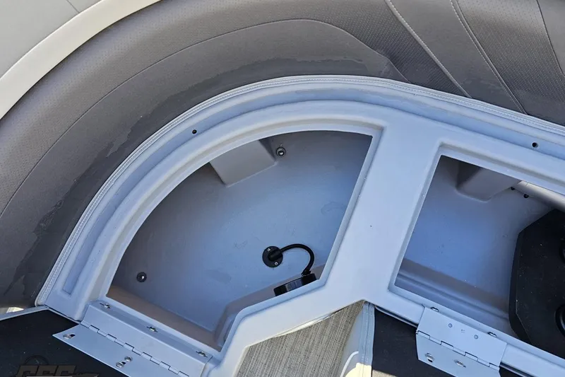 Slide: The Image of 2022 Bennington SX 21 Fishing boat storage compartment with gray interior and seating. - 84