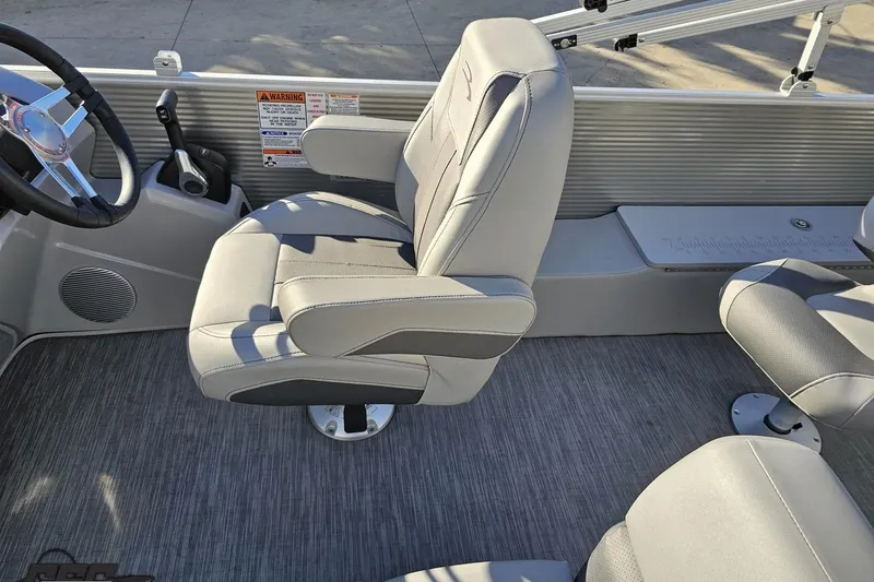 Slide: The Image of 2022 Bennington SX 21 Fishing boat interior with gray captain's chair and steering wheel. - 95