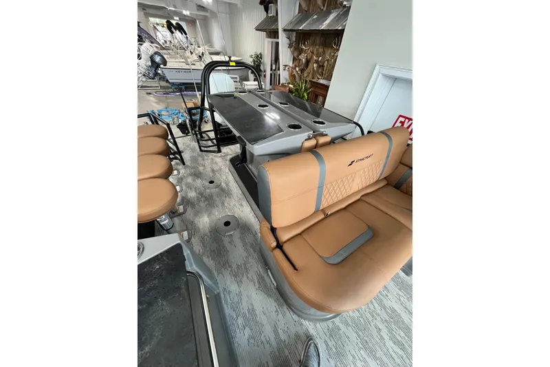 Slide: The Image of 2026 Starcraft RX 25 DL DC boat interior with tan seating and sleek design. - 6