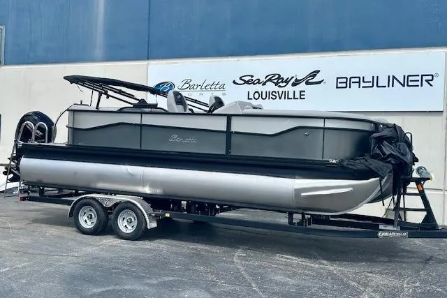 The Image of 2026 Barletta A22QC pontoon boat on trailer at dealership. - 0