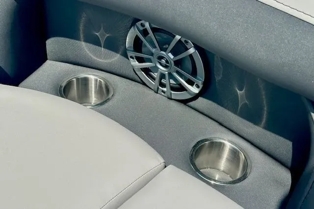 Slide: The Image of 2026 Barletta A22QC boat interior with speaker and dual cup holders. - 12