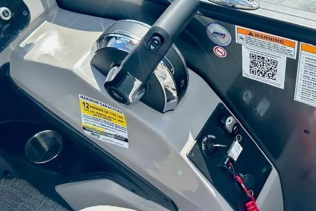 Slide: The Image of Control panel of 2026 Barletta A22QC boat with throttle and warning labels. - 13
