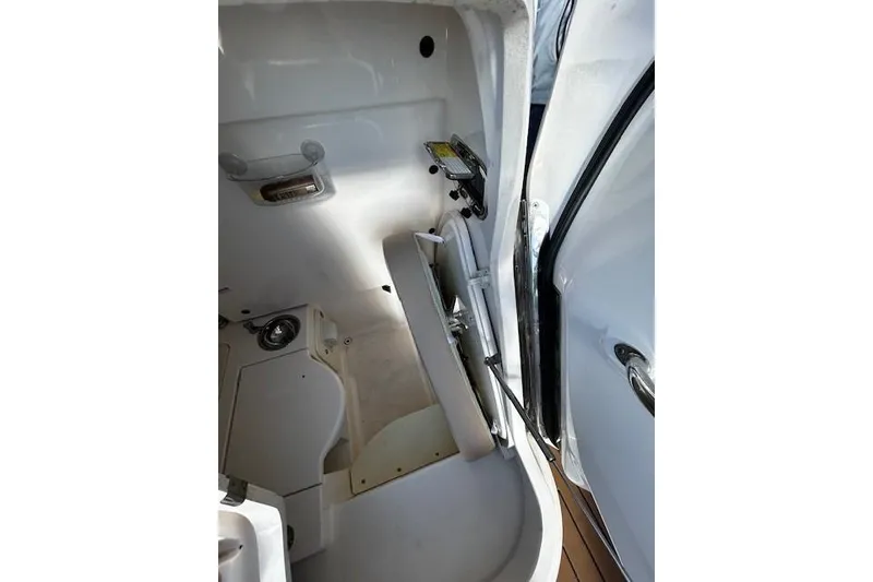 Slide: The Image of Interior view of 2014 Pursuit ST 310 Sport boat cabin with open door. - 14