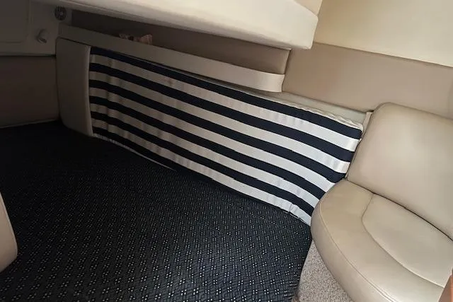 Slide: The Image of Interior of 2006 Bayliner 325 boat with striped upholstery and beige seating. - 15