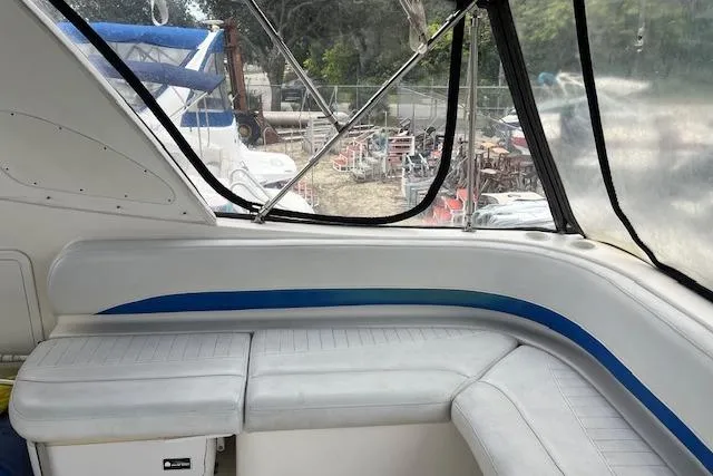 Slide: The Image of 2006 Bayliner 325 boat interior with white seating and blue accents. - 4